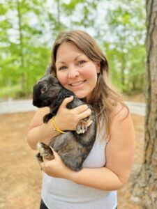 Woman holding a black and brown bunny