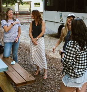4 women talking and laughing outside at Marie Farms